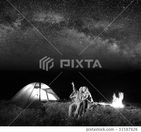 Tourists in camping at night against starry sky 31587826