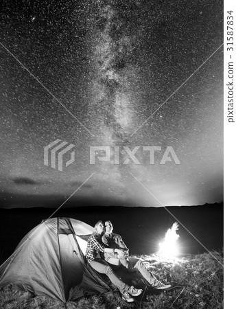 Tourists in camping at night against starry sky Tourists in camping at night against starry sky 31587834