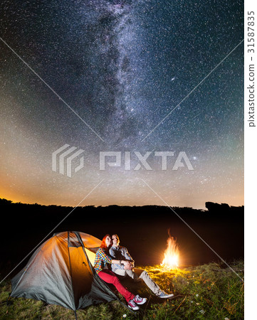 Tourists in camping at night against starry sky Tourists in camping at night against starry sky 31587835