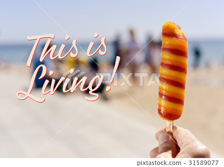 popsicle on the beach and text this is living 31589077