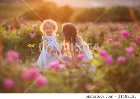 Beautiful child girl with young happy mother are 31589183
