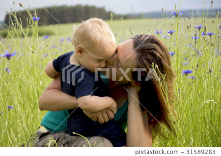 Happy family in the field of blew flowers Happy family in the field of blew flowers 31589283