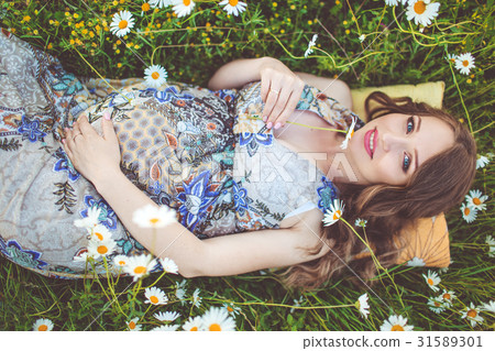 Beautiful pregnant smiling woman lying in the Beautiful pregnant smiling woman lying in the 31589301