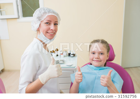Happy child in dentist chair with female doctor Happy child in dentist chair with female doctor 31592756