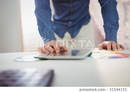 Midsection of man using digital tablet 31594155