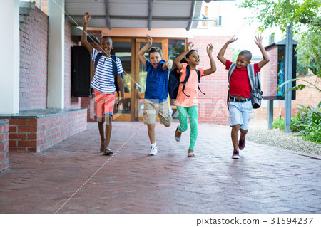 Classmates running at school corridor Classmates running at school corridor 31594237