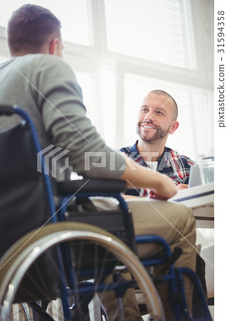 Handicap businessman with colleague in creative office 31594358