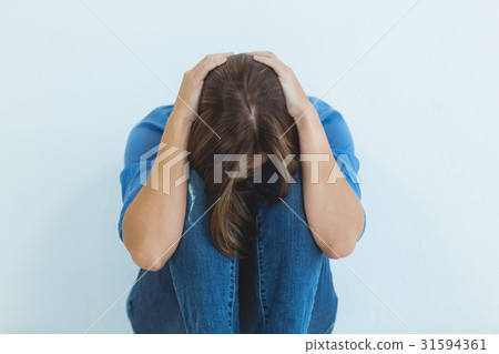 Sad woman sitting at home 31594361