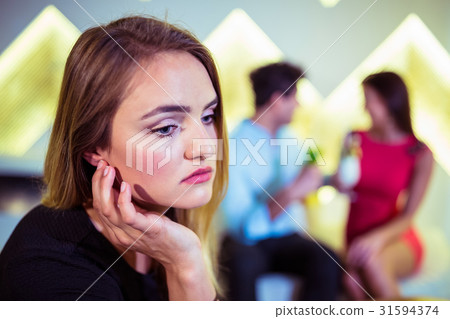 Sad woman against couple Sad woman against couple 31594374