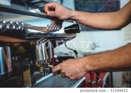 Close-up of barista using espresso machine at coffee house 31594422