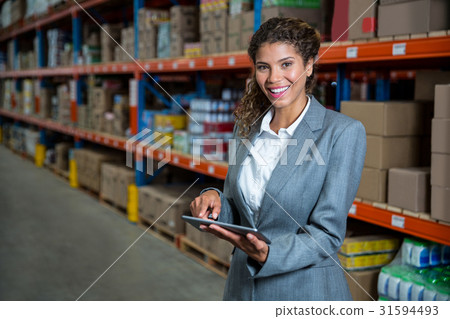 Business woman posing with her tablet 31594493