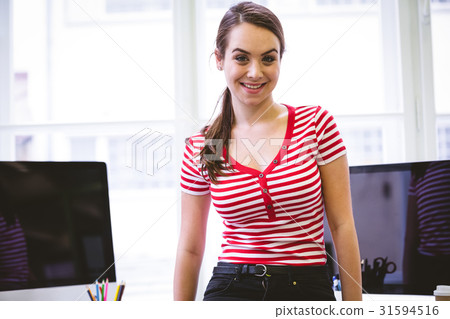 Portrait of confident businesswoman standing at creative office 31594516