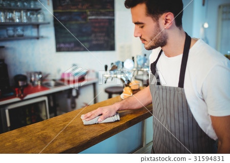 Handsome worker cleaning counter Handsome worker cleaning counter 31594831
