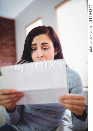 Shocked beautiful woman holding letter Shocked beautiful woman holding letter 31594845