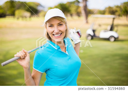Happy mature woman carrying golf club 31594860