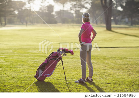 Rear view of mature golfer with hands on hip 31594986