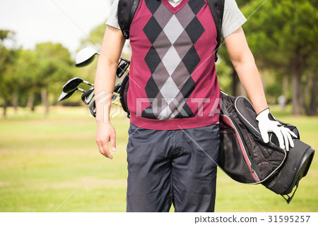 Midsection of man wearing golf bag 31595257