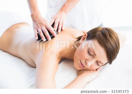 Beautiful woman enjoying hot stone massage 31595373