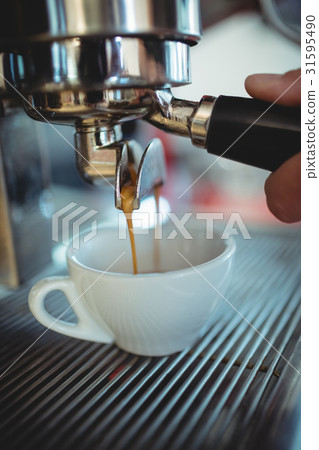 Cropped image of waiter holding machine handle at cafe Cropped image of waiter holding machine handle at cafe 31595490