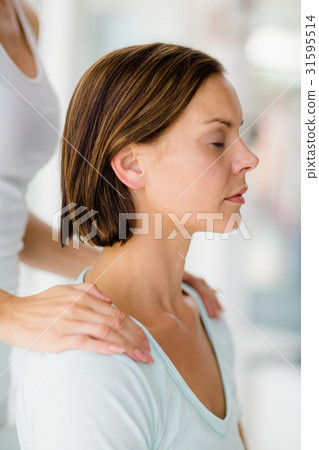 Cropped image of masseur giving massage to woman Cropped image of masseur giving massage to woman 31595514