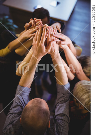 Coworkers high fiving in creative office Coworkers high fiving in creative office 31595592