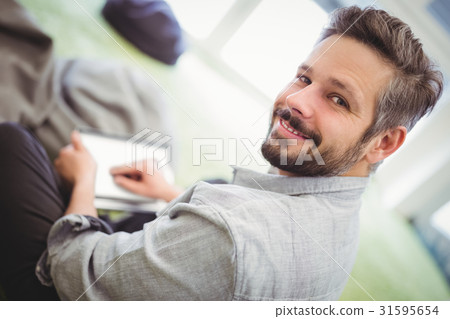 Businessman holding digital tablet in creative office 31595654