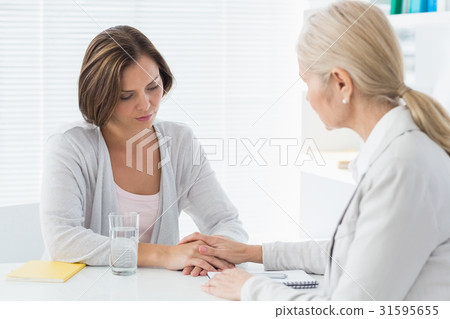 Therapist comforting her patient Therapist comforting her patient 31595655
