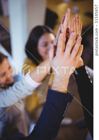 Creative business people high fiving 31595657