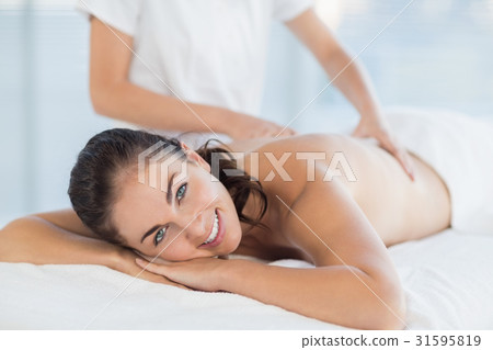 Portrait of smiling woman enjoying massage Portrait of smiling woman enjoying massage 31595819