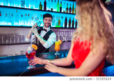 Bartender preparing cocktail for customer Bartender preparing cocktail for customer 31595824