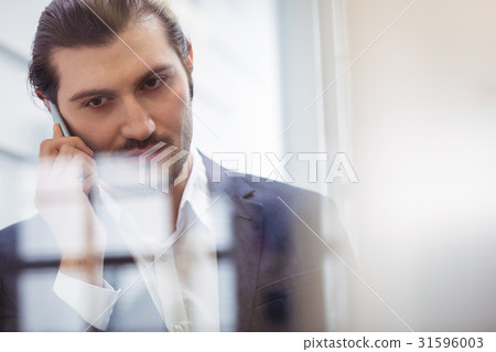 Businessman talking on phone Businessman talking on phone 31596003