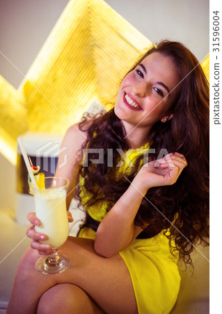 Portrait of happy woman enjoying drink in nightclub 31596004
