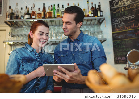 Young baristas with digital tablet at cafe 31596019