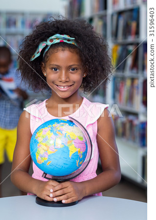 Smiling girl with globe 31596403