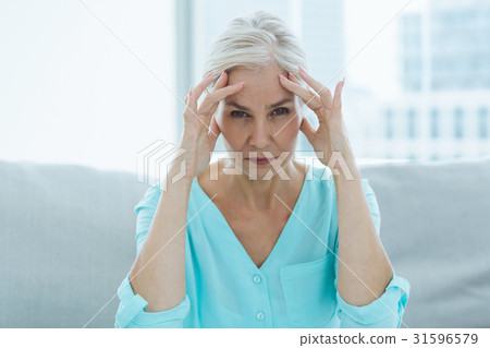 Portrait of senior woman suffering headache Portrait of senior woman suffering headache 31596579