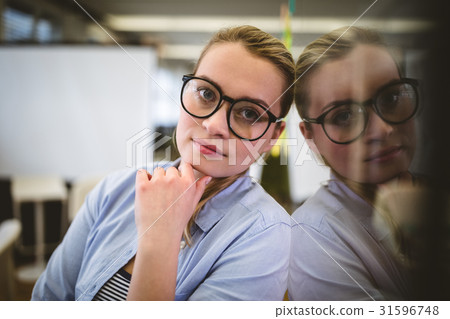 Businesswoman leaning on glass 31596748