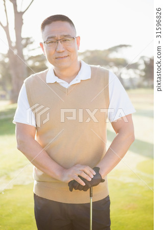Portrait of golfer posing with his golf club 31596826