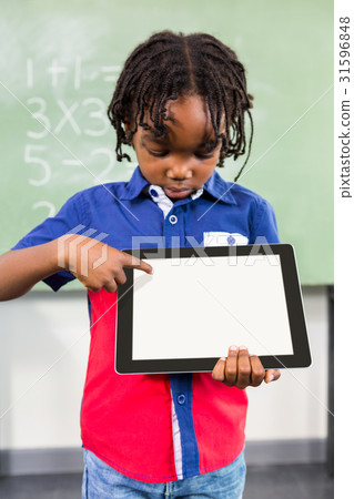 Boy using digital tablet in classroom 31596848