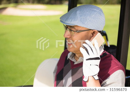 Profile view of golfer smiling and calling 31596870