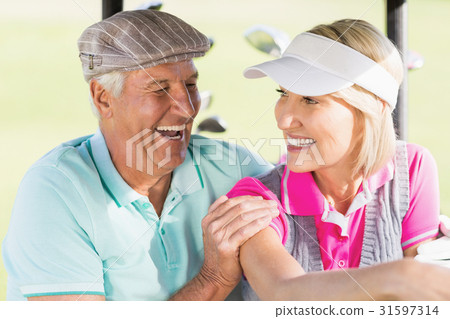 Cheerful golfer couple Cheerful golfer couple 31597314