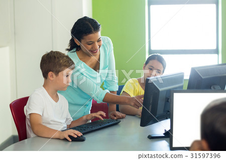 Teacher teaching computer to children Teacher teaching computer to children 31597396