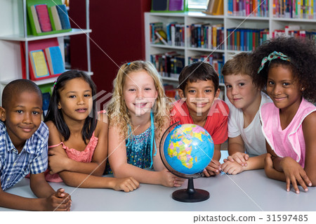 Smiling children with globe on table Smiling children with globe on table 31597485
