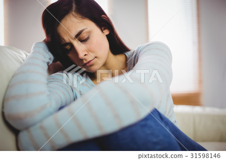 Sad yooung woman at home Sad yooung woman at home 31598146