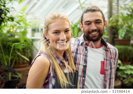 Portrait of happy gardeners at greenhouse Portrait of happy gardeners at greenhouse 31598414