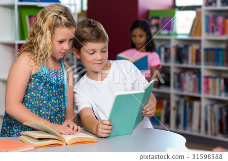 boy showing book to classmate boy showing book to classmate 31598588