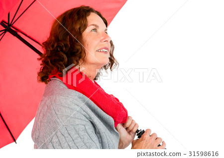 Thoughtful mature woman holding umbrella Thoughtful mature woman holding umbrella 31598616