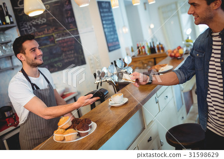 Happy customer and waiter at coffee shop Happy customer and waiter at coffee shop 31598629