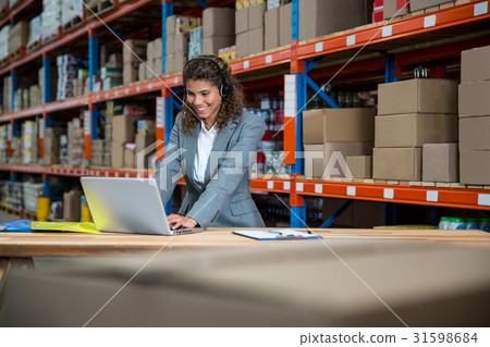 Business woman is talking with a headset 31598684