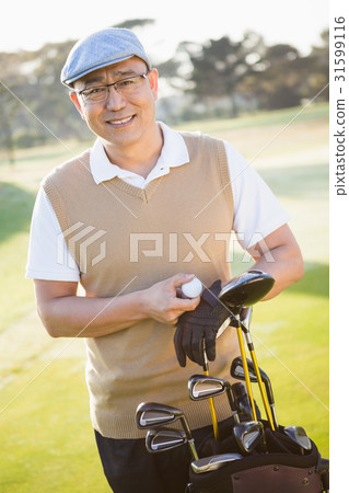 Portrait of golfer posing with his golf equipments 31599116