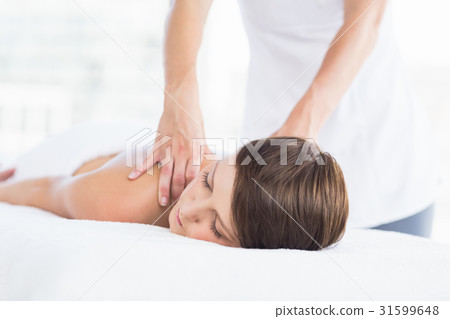 Midsection of masseuse giving massage to woman Midsection of masseuse giving massage to woman 31599648